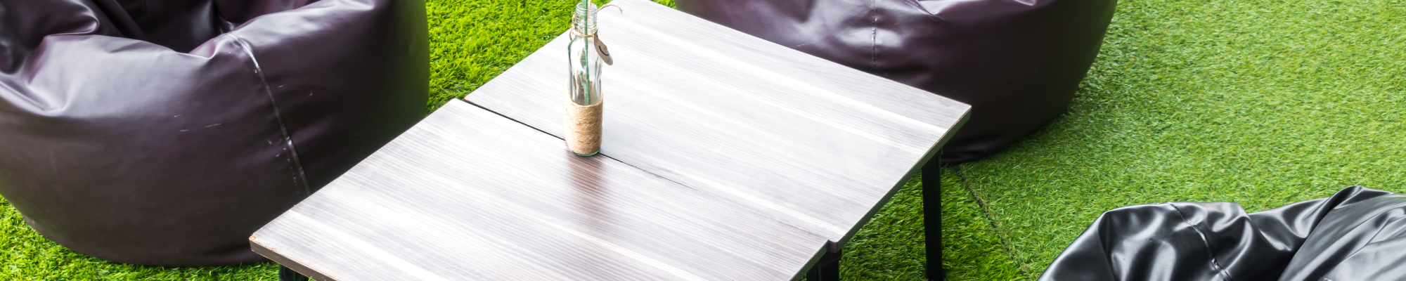 Artificial-Turf-With-Beanbags-And-Table-On-top