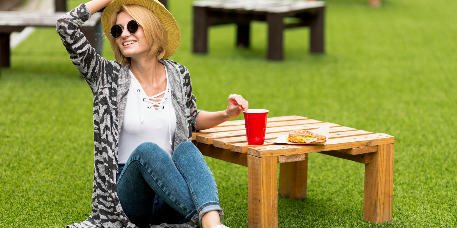 woman-holding-her-hat-grass-field-1600x800